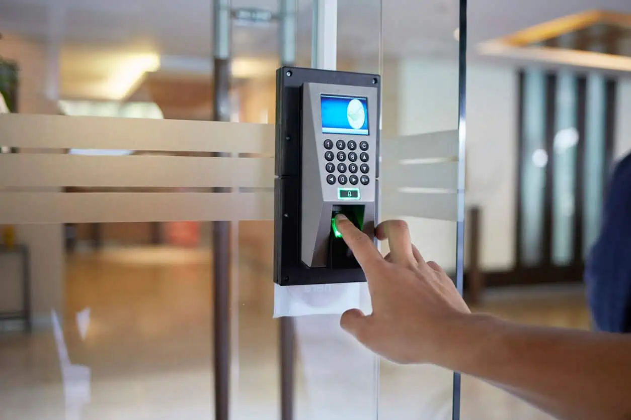 a-man-finger-give-attendance-on-biometric-scanner-and-for-door-opening